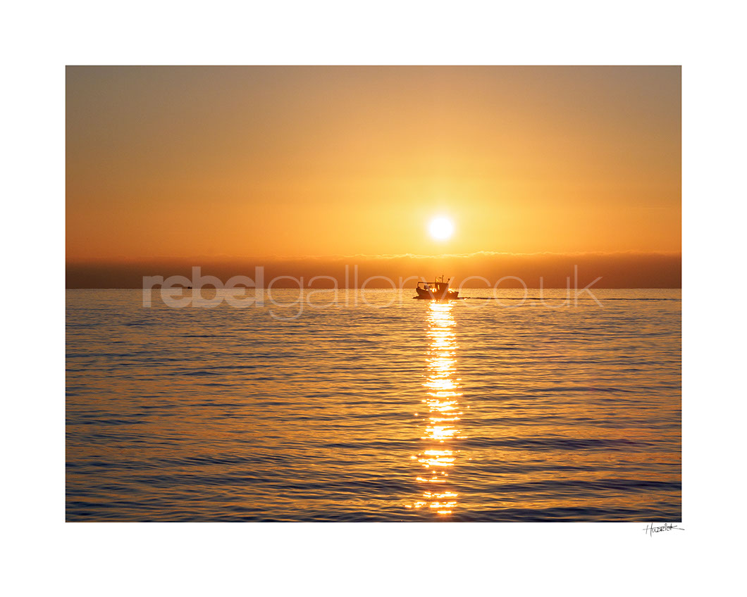 Photograph of Hastings Trawler in golden sunrise by Hastings Photographer Jon Huldrick Wilhelm.